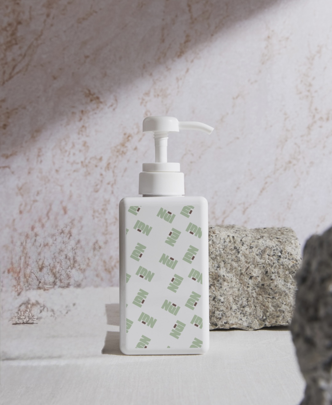 NūI pump bottle on stone