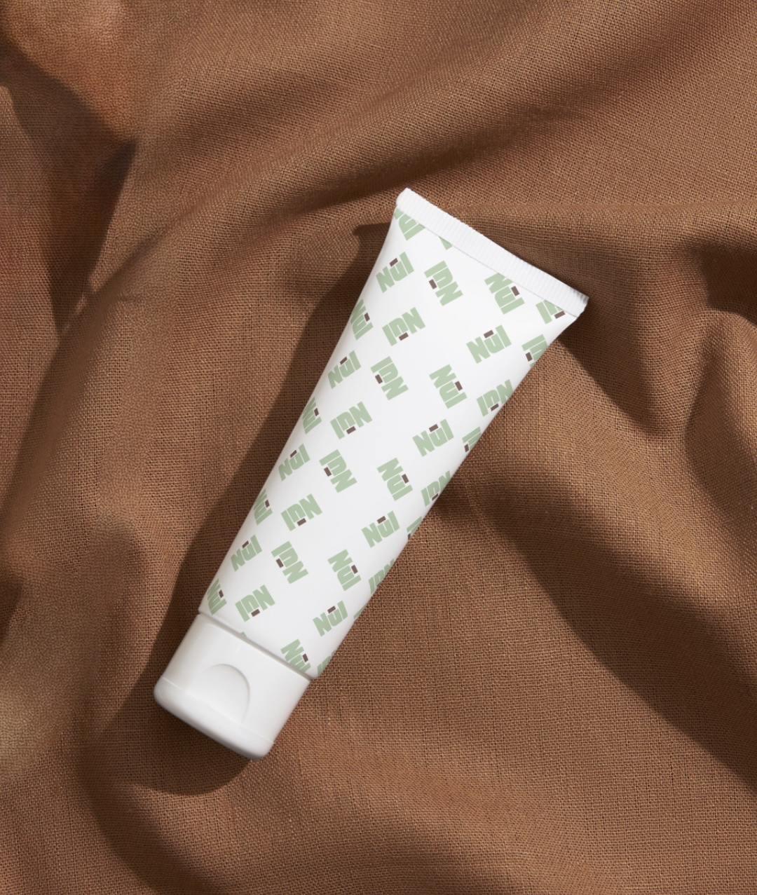 NūI tube on brown linen